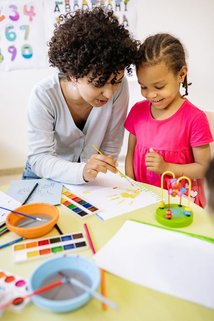 Early years practitioner supporting a child