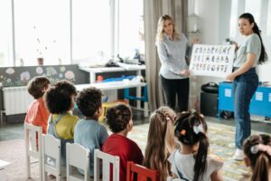 An early years practitioner engaging a small group of children in an activity
